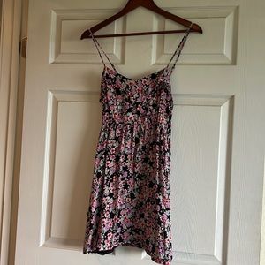 Black Sun dress with pink, purple, and baby blue floral pattern.